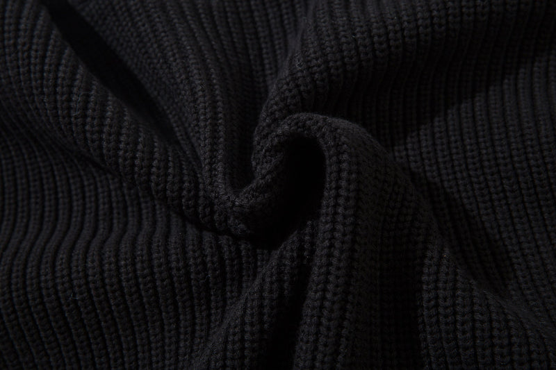 Close-up of black ribbed knit fabric with folded texture detail
