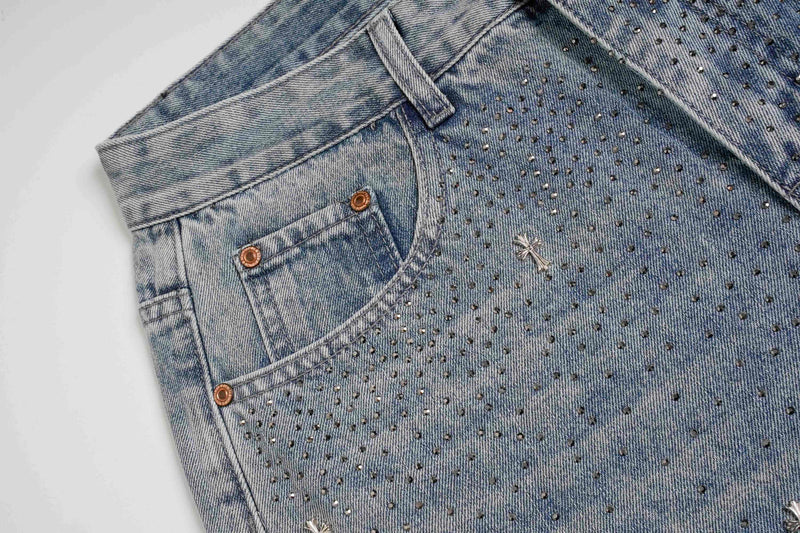 Close-up of light wash jeans front pocket and rhinestone detailing