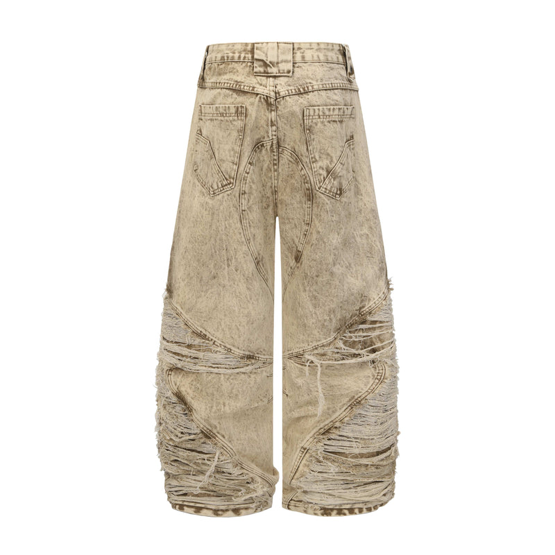 Back view of beige distressed wide-leg jeans with panel seams and frayed hems