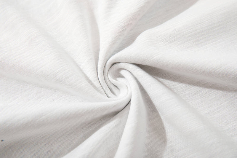 White cotton tee fabric texture with soft spiral folds and smooth knit detail
