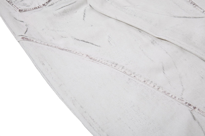 Close-up of back leg fabric on white washed denim pants with diagonal seam