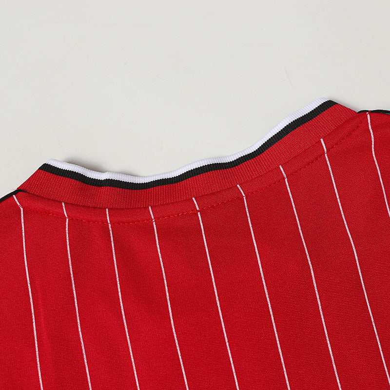 Red pinstripe soccer jersey with black and white ribbed collar detail and vertical white stripes