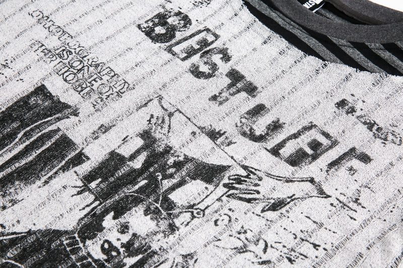 Close-up of the graphic text and print on the gray sweater front