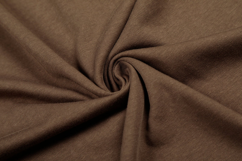 Close-up of brown T-shirt fabric draped in soft folds