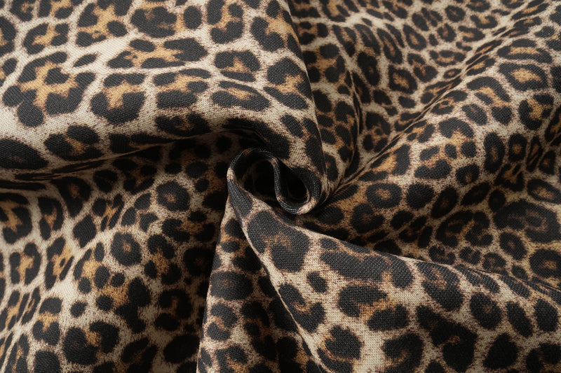 Close-up of gathered leopard print fabric with visible weave and folds