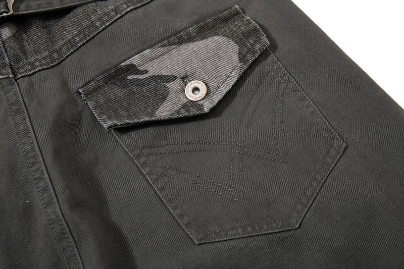 Close-up of black rear pocket with camo flap and stitched detail