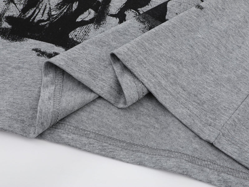 Gray oversized graphic tee with black art portrait print and folded short sleeves on a clean white background