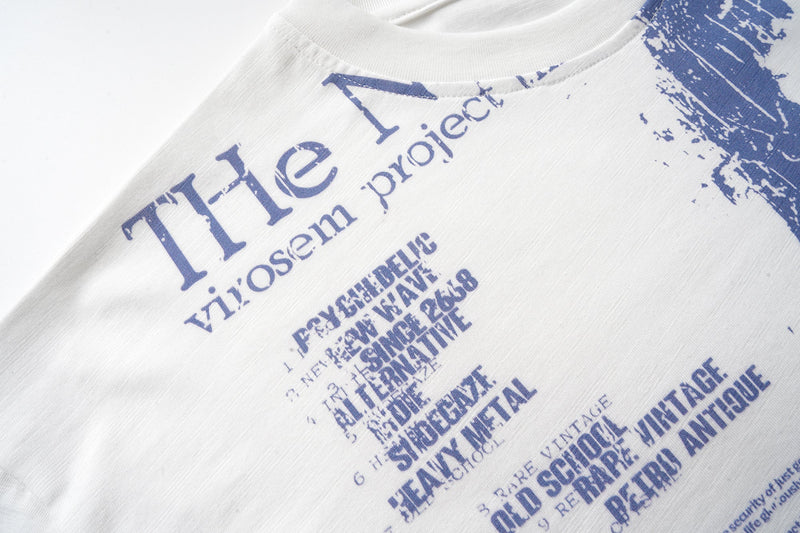 Front chest graphic on off-white long sleeve tee with blue text blocks and portrait
