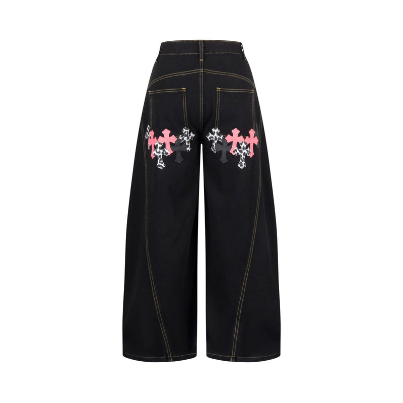 Back view of black wide-leg jeans with cross patches across the seat and back pockets