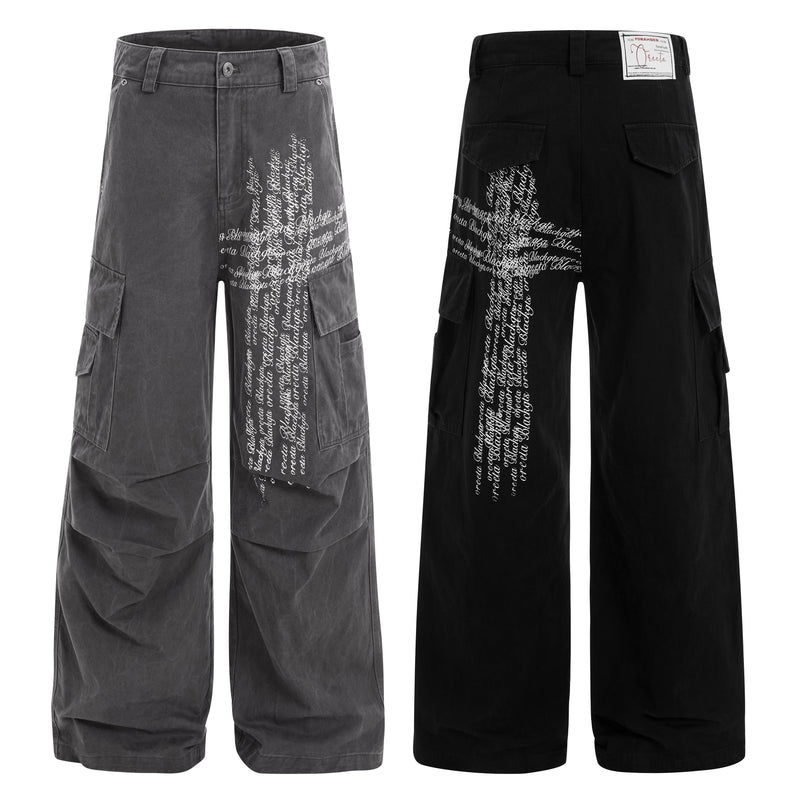 Black cargo pants front and back views with white cross script graphic and wide legs