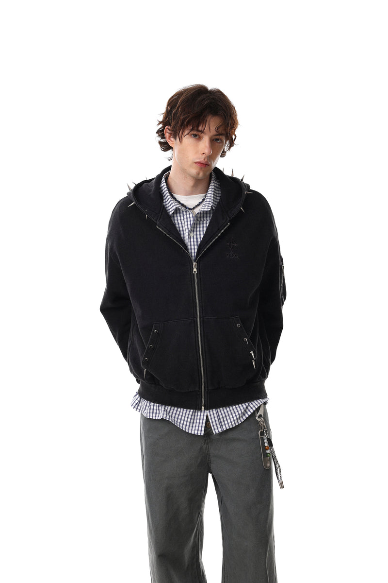 Black studded zip-up hoodie worn over a plaid shirt, front view