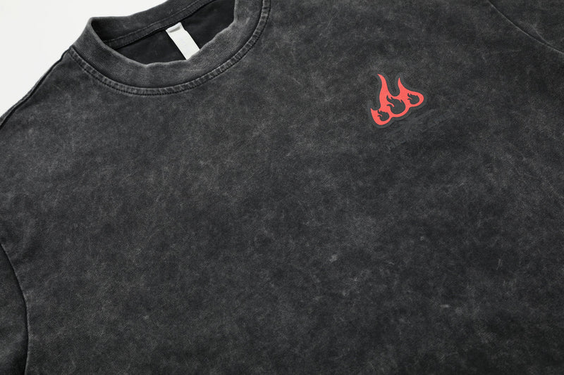 Washed black oversized cotton T-shirt with red flame graphic on the chest