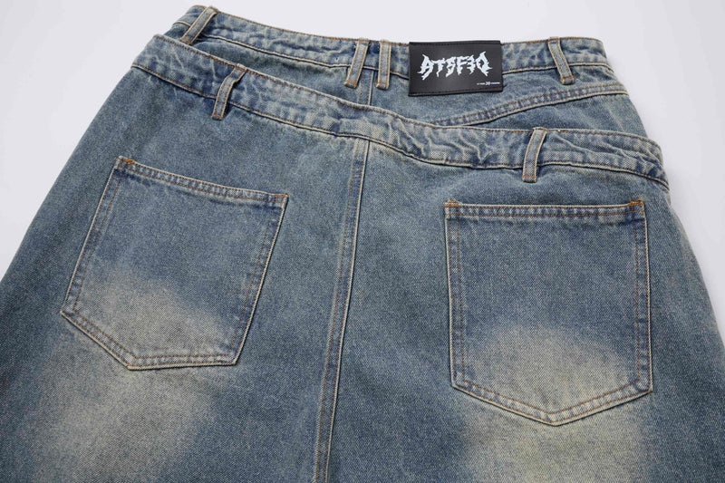 Back view of light blue denim shorts with layered waistband and two back pockets
