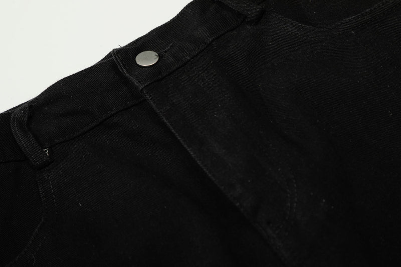 Close-up of black waistband seam and metal button