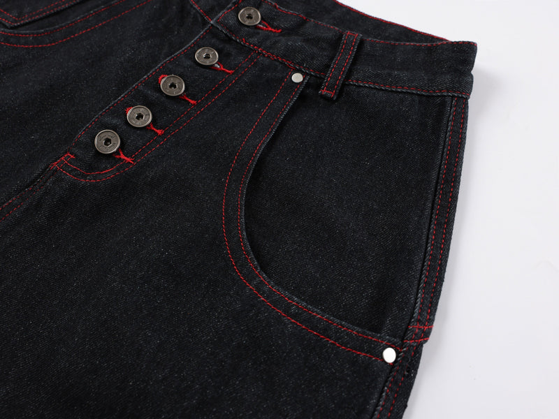 Close-up of front right waistband and pocket on black denim with red stitching