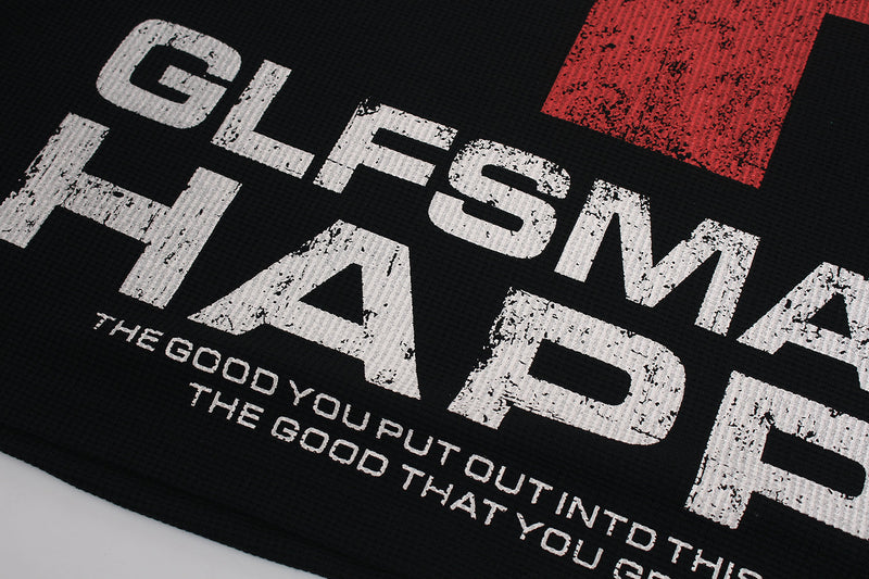 Front graphic close-up showing white distressed text and part of the red cross on black waffle knit sweatshirt