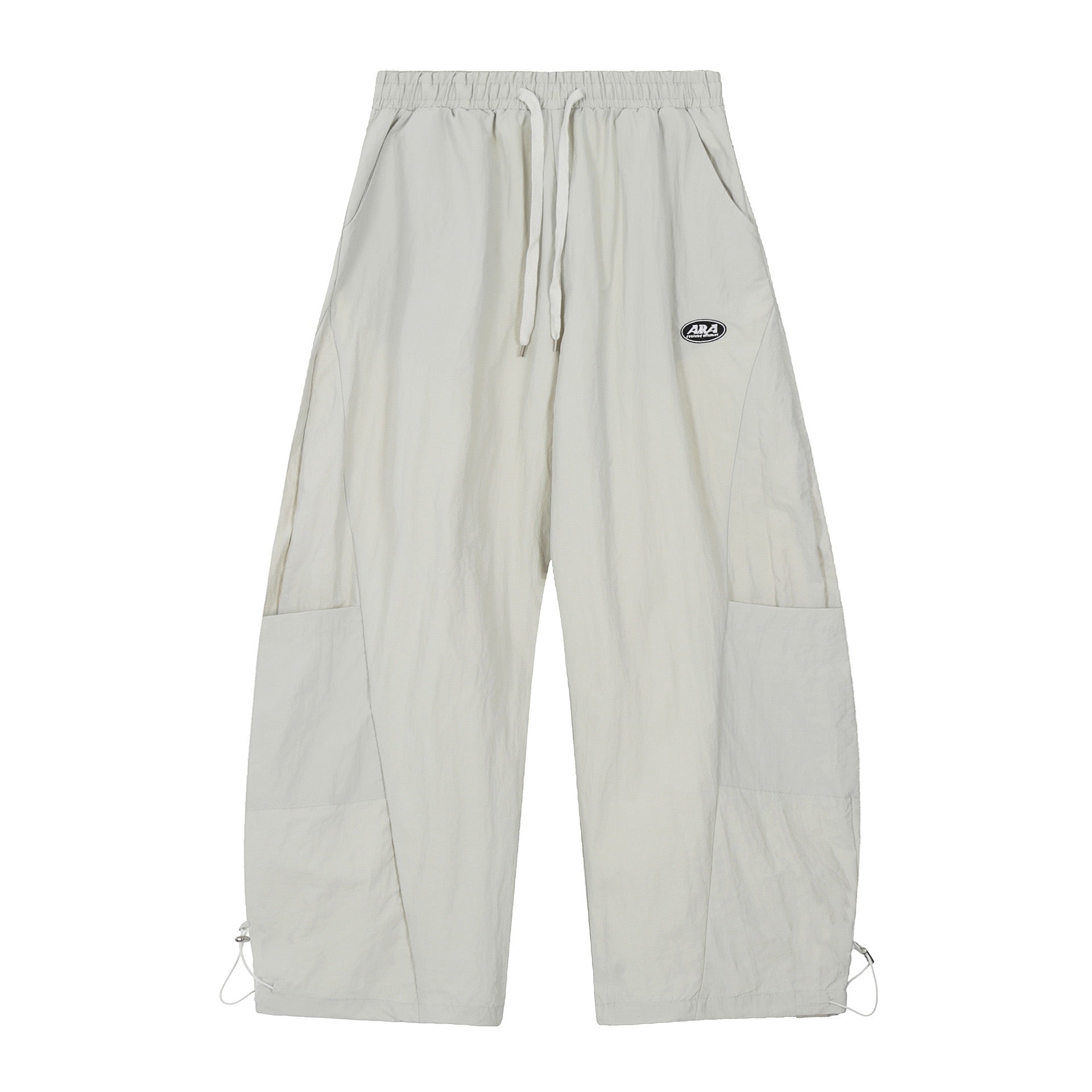 Off-white nylon wide-leg cargo pants with side patch pockets, drawstring waist, and ankle toggles, front view