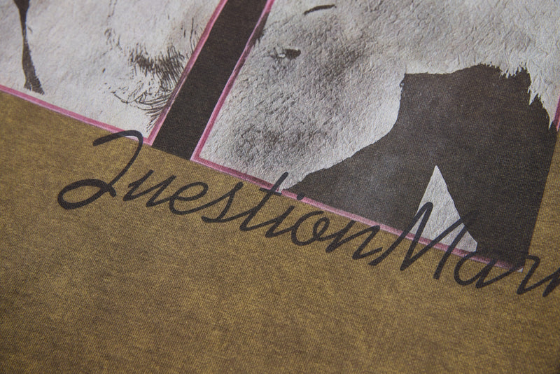 Front graphic close-up with script text across brown long sleeve tee