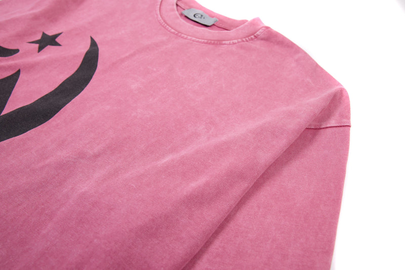 Angled front view of pink graphic cropped tee showing shoulder, neck, and chest print