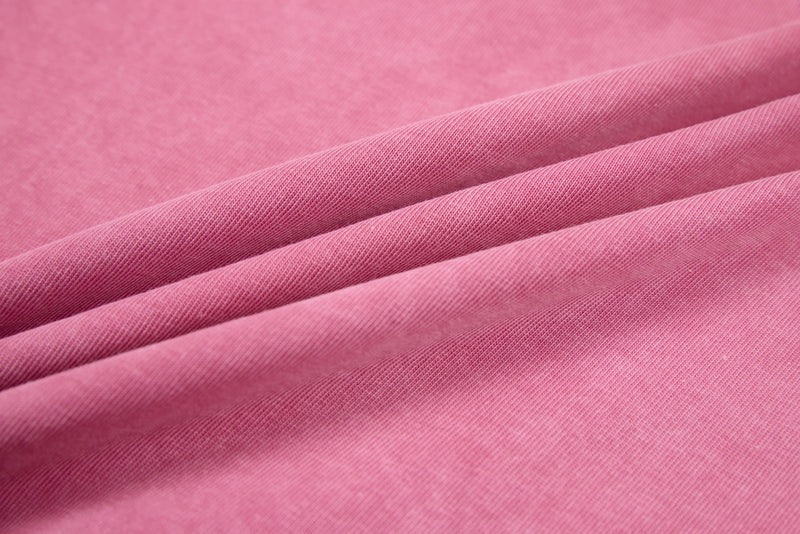 Close-up of pink heavyweight cotton fabric with visible weave and drape folds