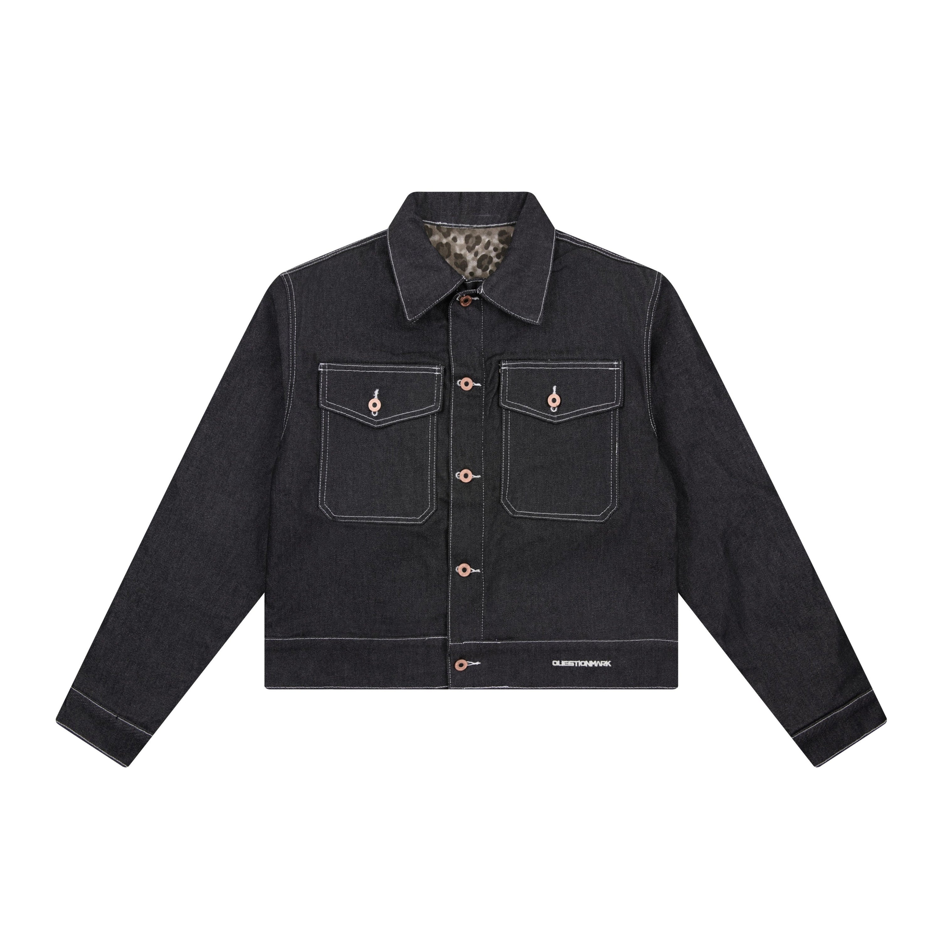Front view of Questionmark black denim jacket with white contrast stitching, dual flap chest pockets, and copper button closu