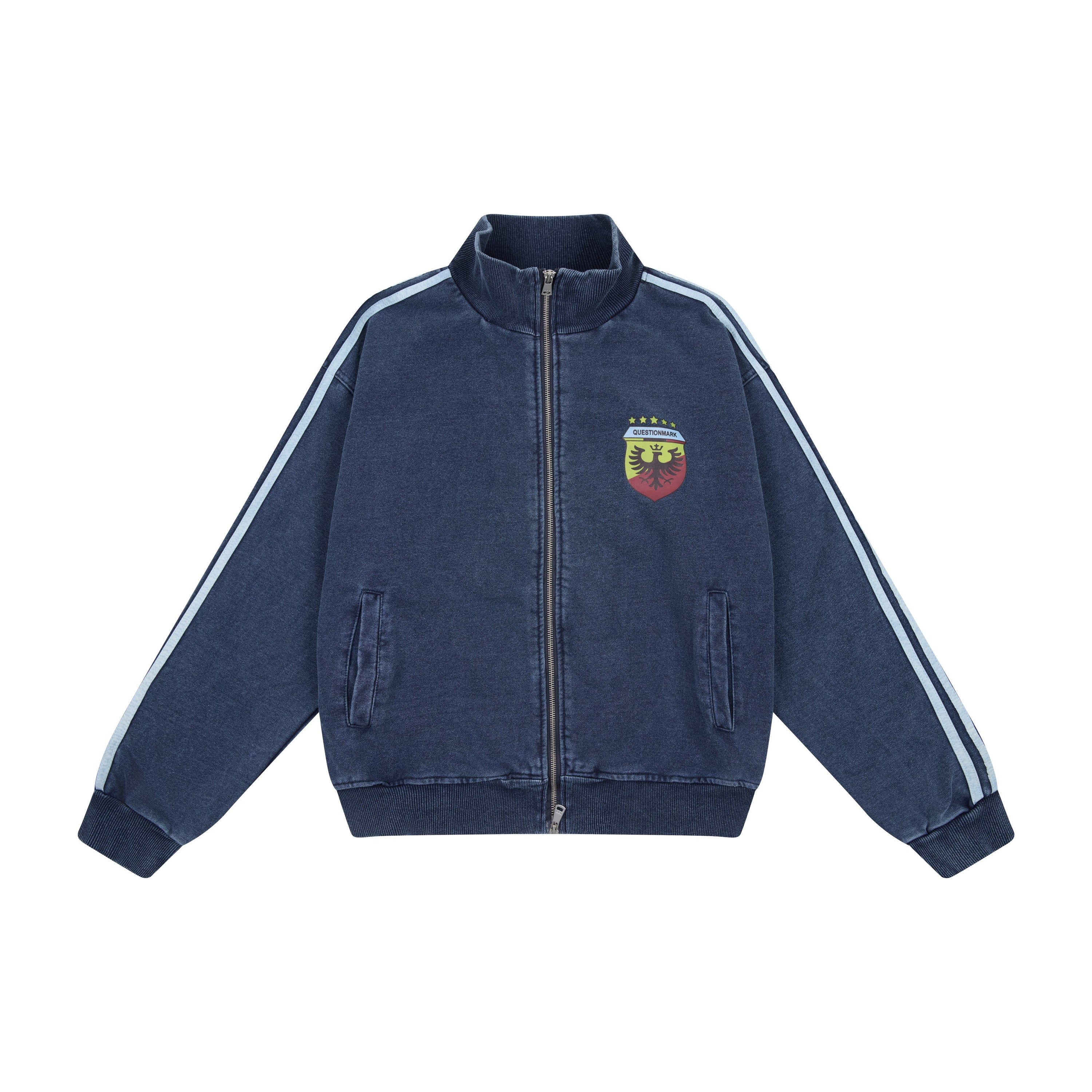 Front view of a washed navy cotton zip-up track jacket with light blue shoulder stripes and a heraldic crest graphic on the l