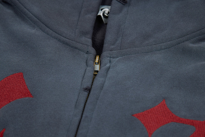 Close-up of front zipper and hood on washed charcoal graphic zip-up hoodie