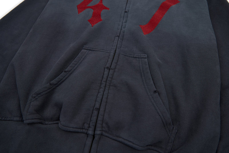 Front view of charcoal hoodie with kangaroo pockets and partial red gothic print