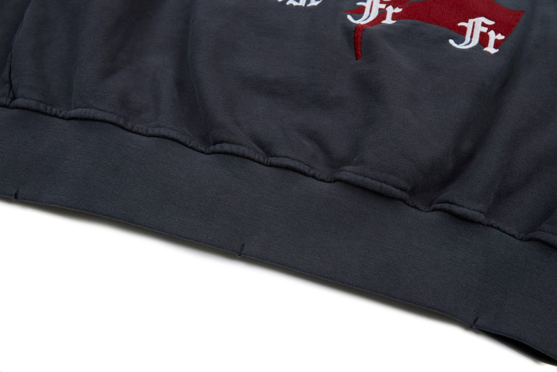 Lower back hem close-up of washed charcoal hoodie with ribbed waistband