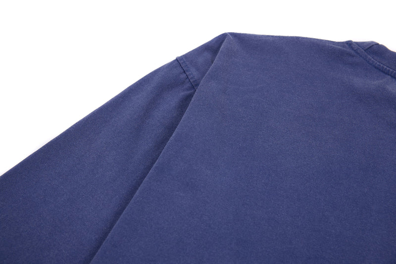 Back shoulder close-up of plain blue long sleeve cropped tee