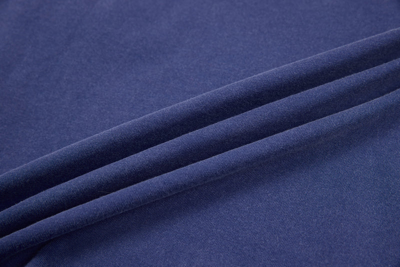 Close-up of blue cotton fabric with soft folds and texture