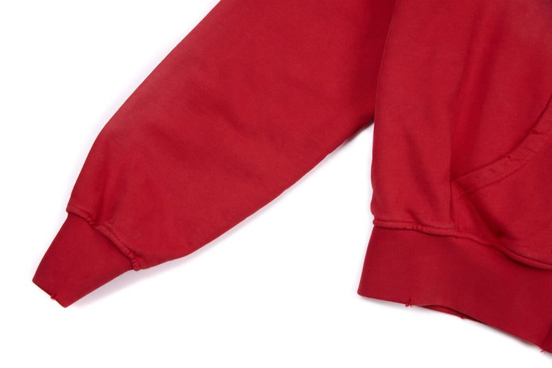 Close-up of red hoodie sleeve and cuff with ribbed hem and seam detail