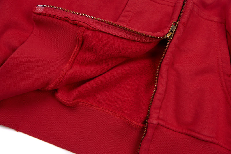 Close-up of red hoodie front opening with gold zipper and fleece interior