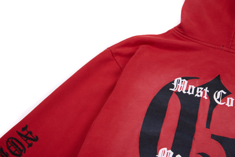 Red zip-up hoodie front view with black gothic graphic and sleeve text