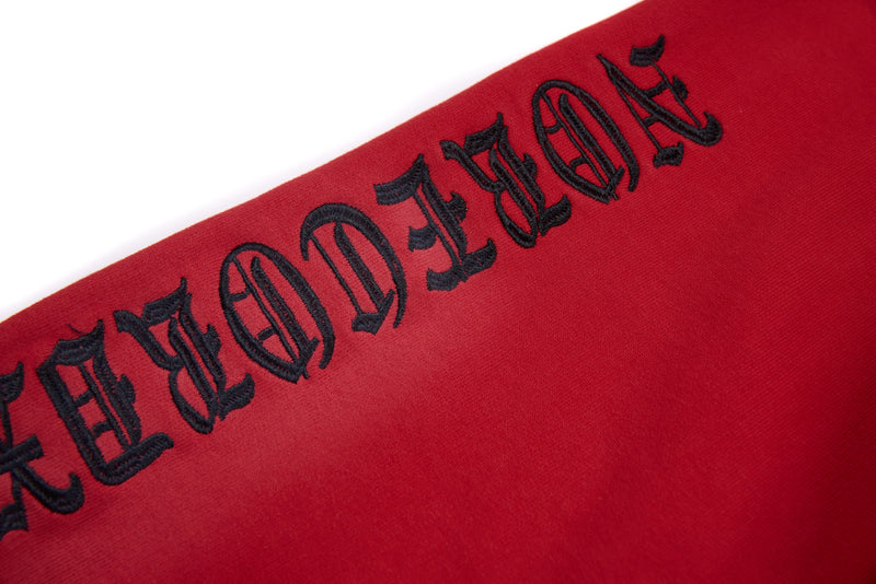 Black gothic text printed along the red hoodie sleeve