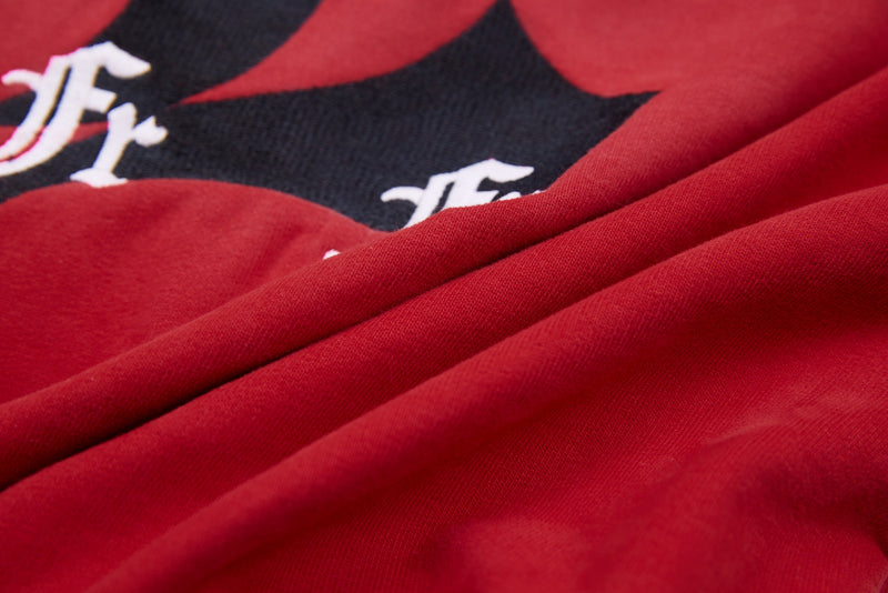 Close-up of red hoodie fabric draped over black graphic print