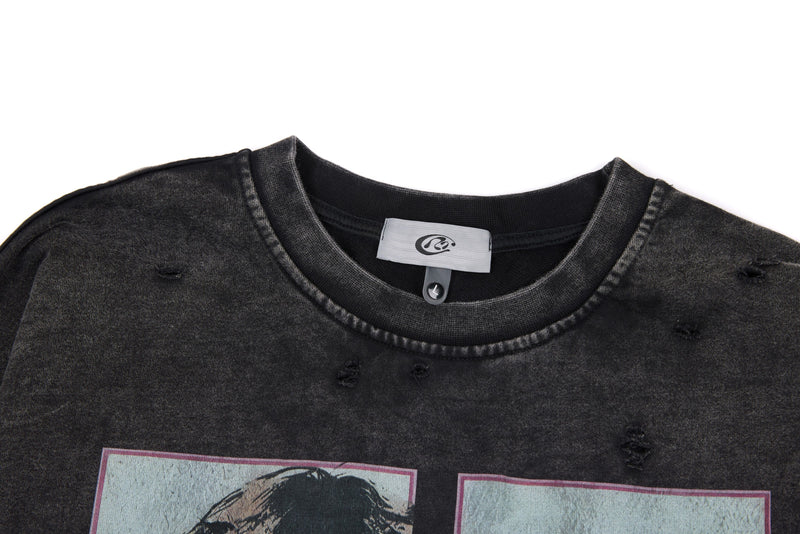 Close-up of black washed tee neckline with label and small distressed holes