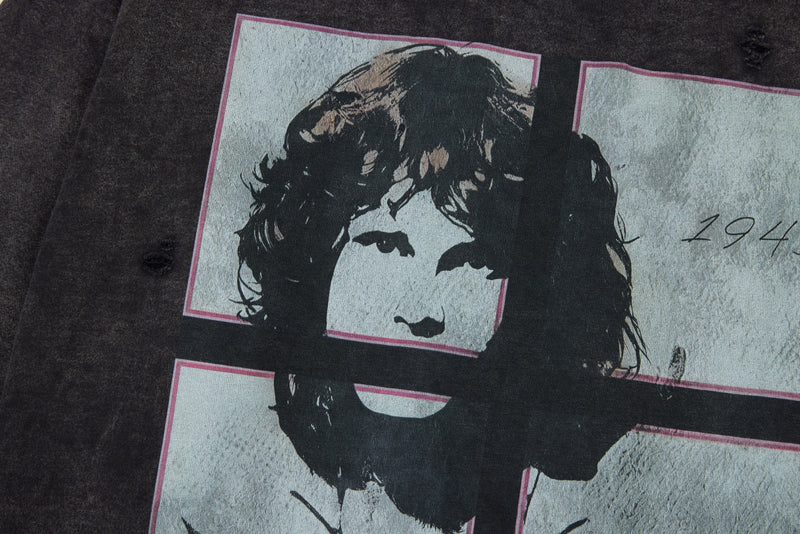 Front graphic close-up on black washed tee with portrait print and script text