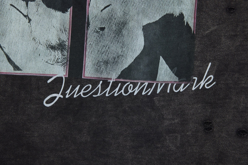 Graphic print close-up on black washed tee with script text across the chest