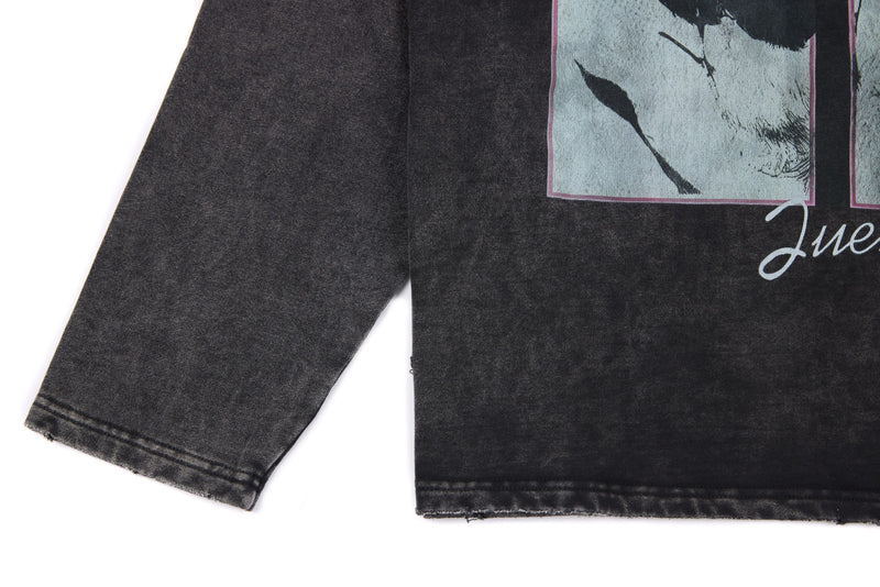 Black washed tee sleeve and lower graphic area with distressed hem detail