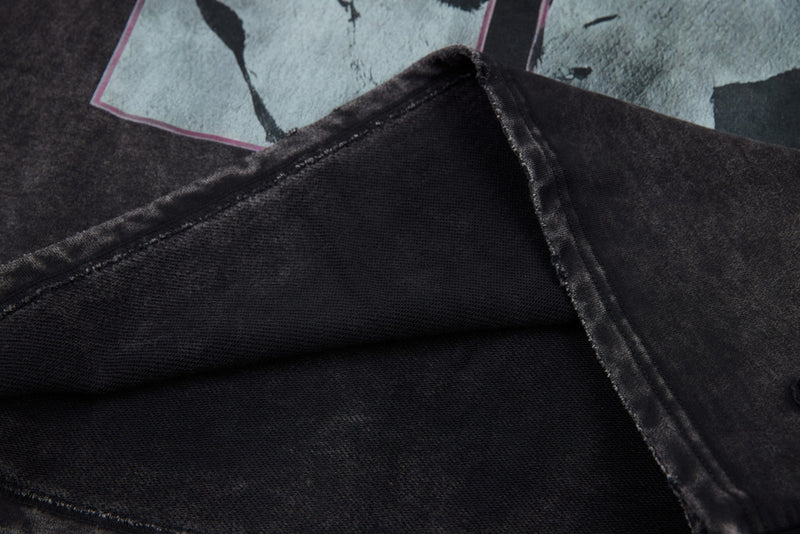 Inside view of black washed tee sleeve seam and stitched construction