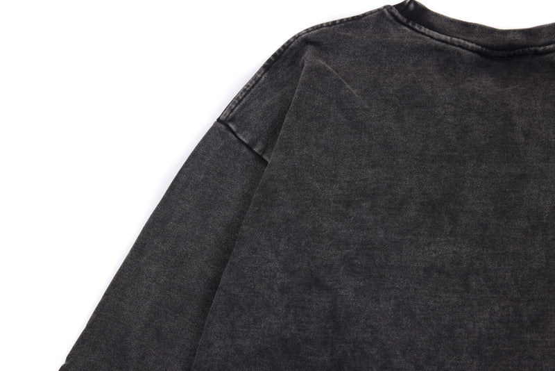 Back upper view of black washed tee with dropped shoulders and faded fabric