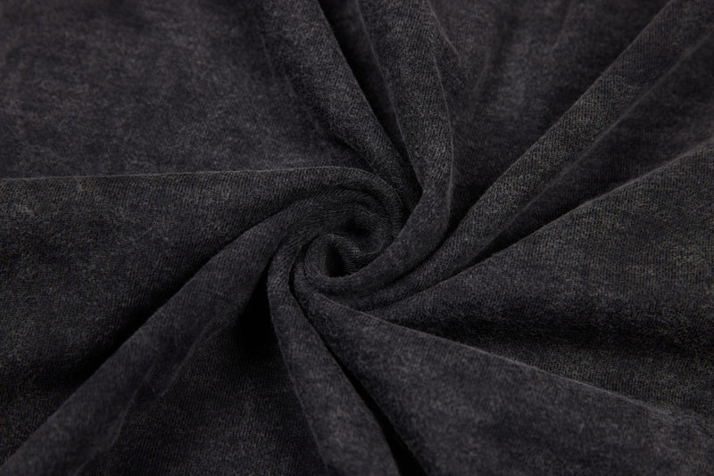 Black washed tee fabric swirl close-up showing lightweight knit and vintage wash