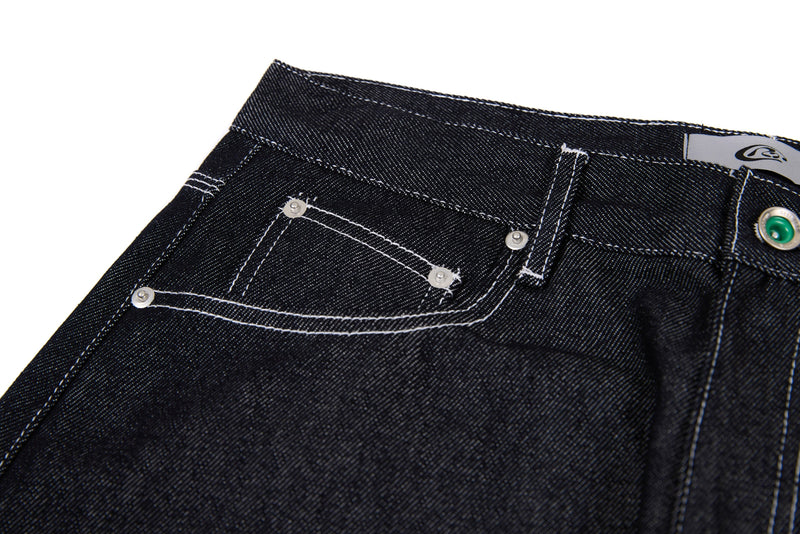Close-up of black jeans back pocket, waistband, and contrast topstitching