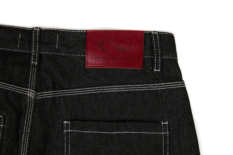 Black denim back waistband with red Questionmark logo patch and contrast stitching