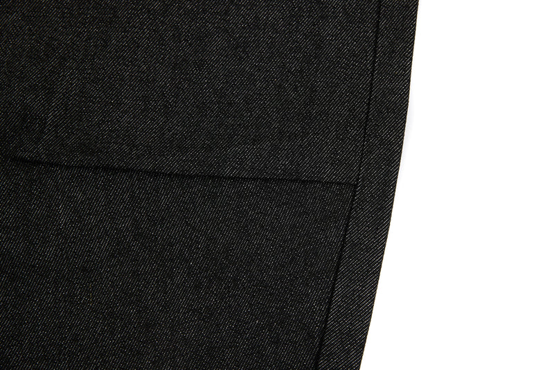 Black denim jeans leg close-up showing straight hem and side seam stitching