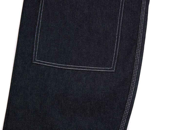 Close-up of large back patch pocket on dark denim pants