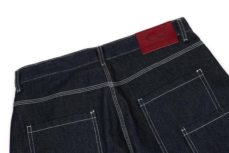 Back waistband of dark denim pants with red logo patch and contrast stitching
