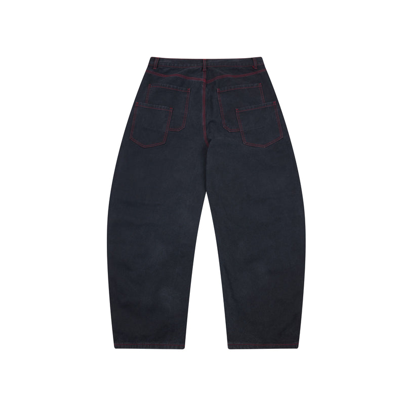 Dark denim barrel leg pants with red contrast stitching, back view