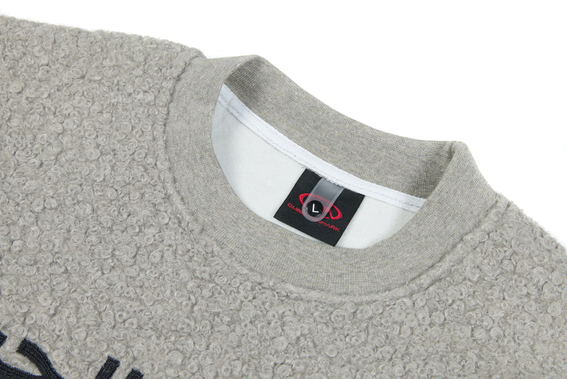 Close-up of light gray crewneck collar and inside neck label on fleece sweatshirt